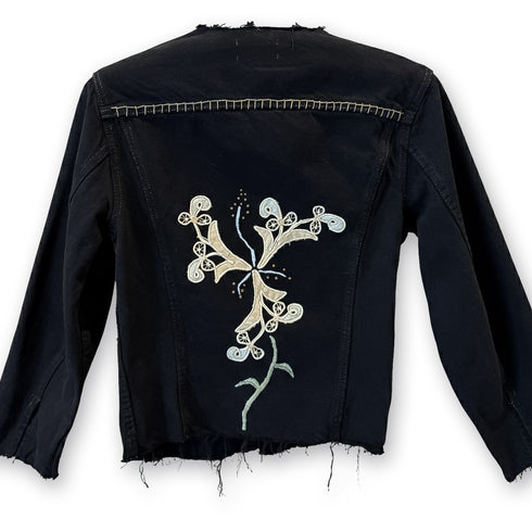 black denim structured jacket with floral artistry, raw edge, and hand-stitched accents<span class='visuallyhidden'>; shop help at 760-978-9297.</span>