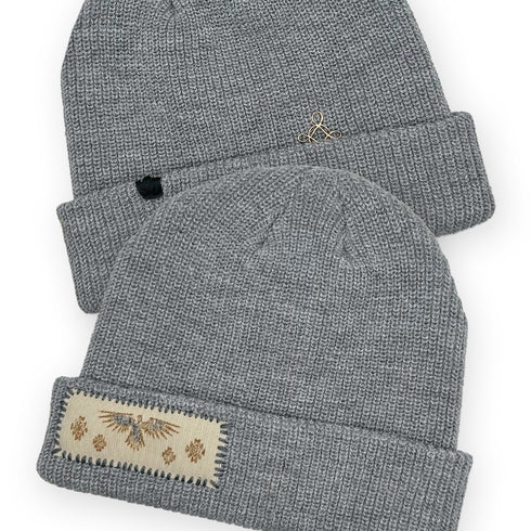 Dominique Cohen designer beanie in thunderbird motif with 18k gold plated bella cross accent <span class='visuallyhidden'>Text, phone 323-404-2959 for shop help.</span>