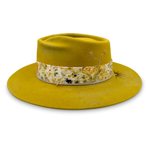 Sunny Side, a twist-front designer fedora in mustard with diamond-kissed gold, silk, and burn motif accents <span class='visuallyhidden'>Text, call 323-404-2959 for shop help.</span>