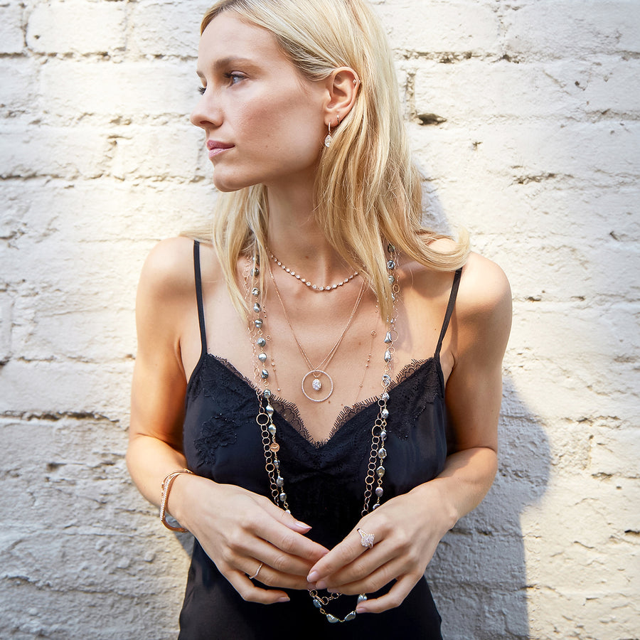 Beautiful woman wearing our 13-piece Glisten delicate rose gold, diamond, Tahitian keshi pearl jewelry collection; phone, text 323-404-2959 for shopping help.