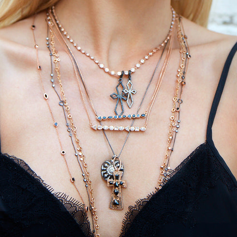 here, hosting one of our bespoke large crosses layered with our vintage pendant necklace<br>shop the look > contrast splendor, up close <span class='visuallyhidden'>Call, text 323-404-2959 for shopping help.</span>