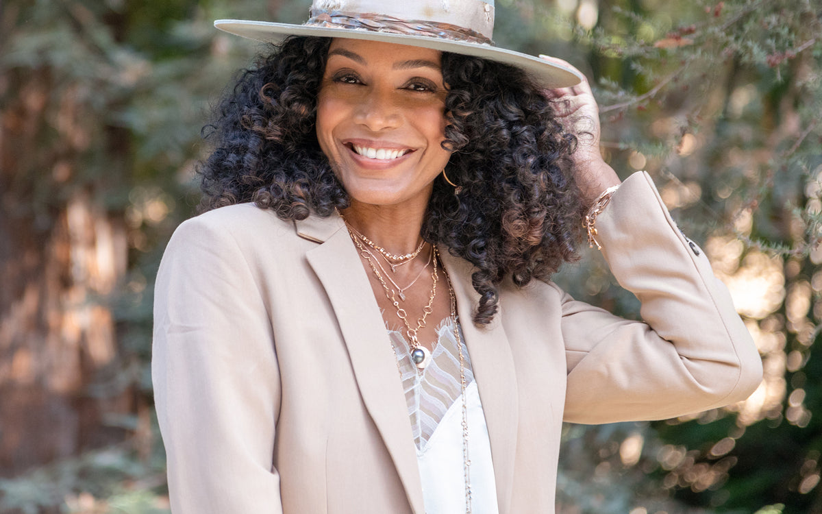 Champagne diamond, white diamond, 18k rose gold, Tahitian pearl, and spinel jewelry collection Color Me in Harmonies on woman standing amongst redwoods; 323-404-2959 for shop help