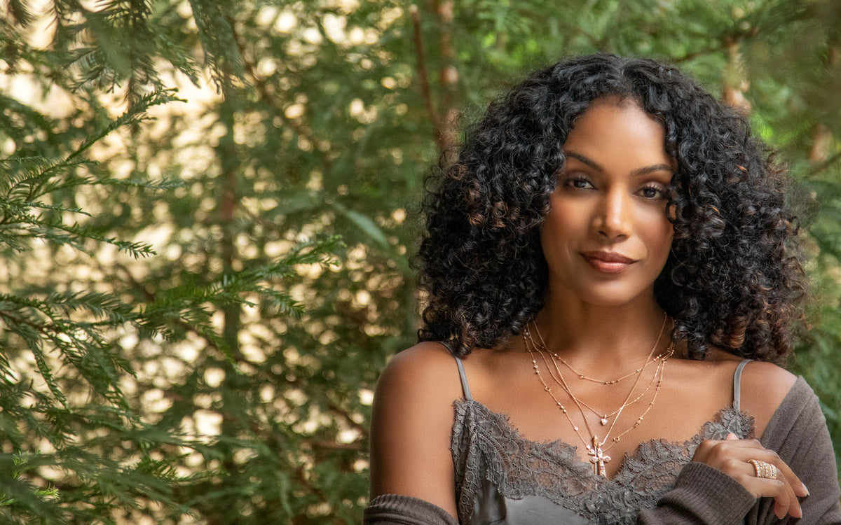 Dominique Cohen pink diamond, champagne diamond, white diamond jewelry collection Heart and Soul, here worn by a beautiful woman standing in a redwood forest; shop help at 760-978-9297