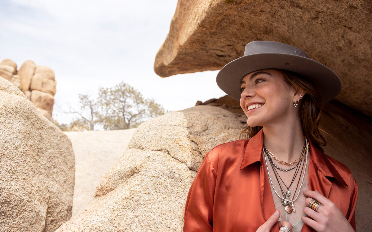 Happy woman wearing stylish black gold + rose gold diamond necklaces and rings; shop the look, earth day <span class='visuallyhidden'>Text, phone 323-404-2959 for shopping assistance.</span>