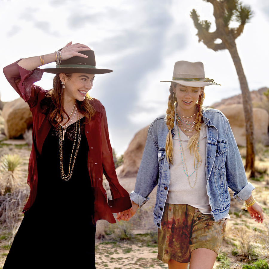 Shop the diamond, turquoise, pink diamond rose gold, yellow gold designer collection Mineral Spirit, shown on friends walking in Joshua Tree park; Text, phone 323-404-2959 for shopping help