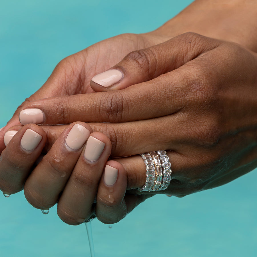 Closeup of hands wearing diamond rings in swimming pool Shop the Look Stone Canyon; call, text 323-404-2959 for shop help