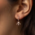 diamond half moon starburst earring in 18k rose gold, on body<span class='visuallyhidden'>; shop help at 760-978-9297.</span>