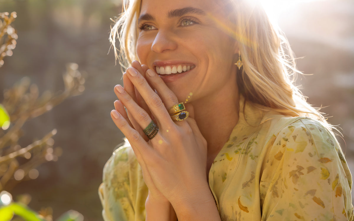 Shop the Look > Sun Dance, a colorfully artful Dominique Cohen designer jewelry and apparel collection with diamonds, emeralds, sapphires, opals and more, worn here by a happy blonde; shop help 760-978-9297