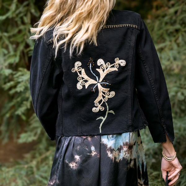 Dominique Cohen black denim structure jacket with floral and other artisan-stitched up-styling<br>shop the look > effortless elegance<span class='visuallyhidden'>; shop help at 760-978-9297.</span>