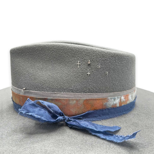 the bezel-sest champagne diamond charm<br>and other left-side designer hat detailing, up close <span class='visuallyhidden'>Text, phone 323-404-2959 for shopping assistance.</span>