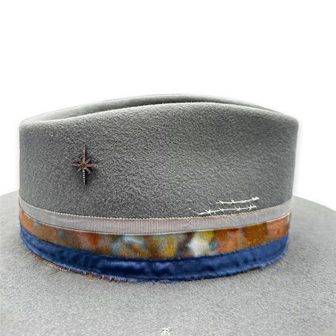 the hat’s blackened sterling, champagne diamond northstar charm,<br>and silk and cotton ribbons, up close <span class='visuallyhidden'>Text, phone 323-404-2959 for shopping assistance.</span>