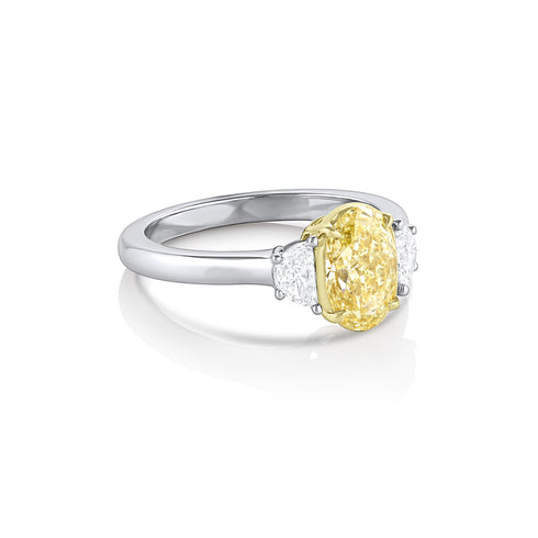 side view of yellow diamond oval ring bookeneded in white diamonds <span class='visuallyhidden'>Call or text 323-404-2959 if you need shopping assistance.</span>